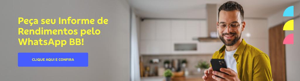Homem sorri olhando para um smartphone em uma cozinha moderna. Ele usa óculos, tem barba e cabelos castanhos, usa uma camisa amarela e uma camiseta branca por baixo. À esquerda o texto: Peça seu informe de rendimentos pelo whatsapp bb. botão: Clique aqui e confira
